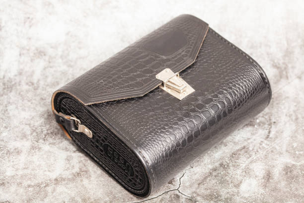istock crocodile leather bag on a gray background.. 1483223879