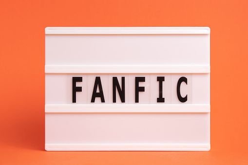 The word fanfic on lightbox isolated orange background. Literary Genres