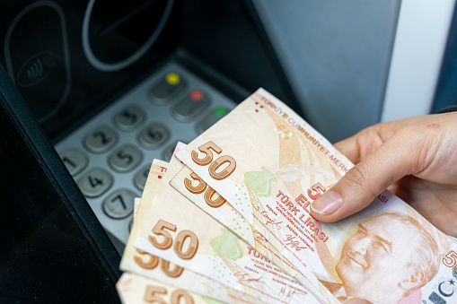 Turkish currency is losing its value and people are constantly withdrawing money from ATMs.