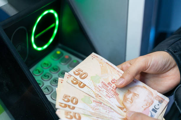 istock Woman withdrawing money from ATM 1483225579