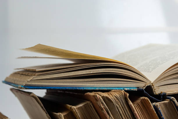 istock Stack of hardcover old books with an open book on white background. Bookshelf shop, Knowledge publications, literature. Bookish bookstore bookshop 1483226261