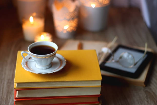 istock Books, Glasses, E-Reader, Pen, Tea, Cookies and Candles 1483226331