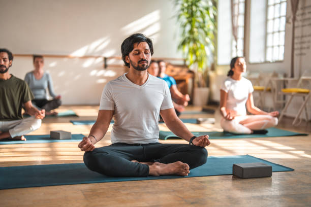 istock Handsome  Male Indian Yoga  Teacher With Mixed Student Group 1483227673