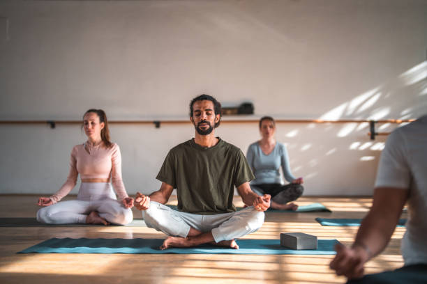 istock Handsome Middle Eastern   Yoga  Practitioner Meditating With Caucasian Women 1483227688
