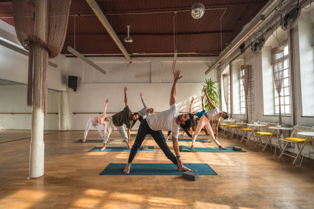 istock Mixed Group of Mid Adult People During Morning Stretch Routine 1483227703