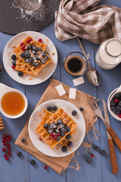 istock Waffles with red currant and blueberries on white dish. 1483227734