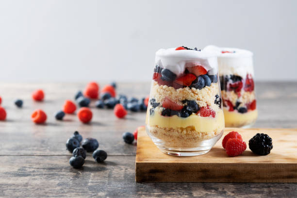 istock Trifle dessert with berries and cream on wooden table 1483227989