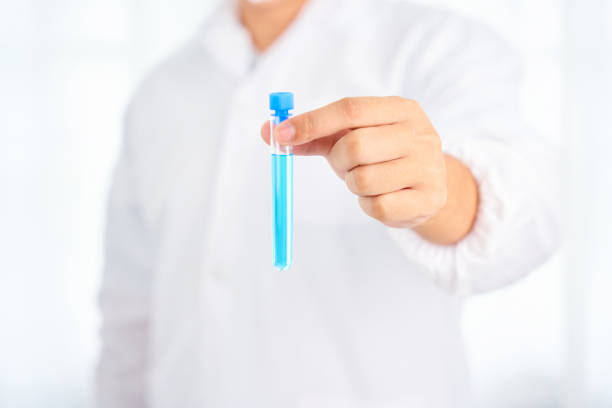 Asian scientist with science research biology with blue liquid on white background
