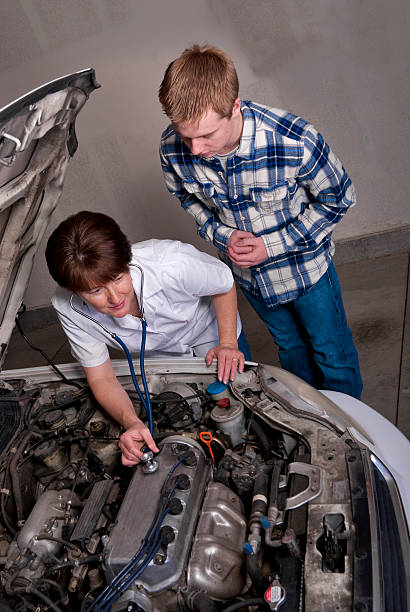 istock Nurse gives car engine a check up 148323204