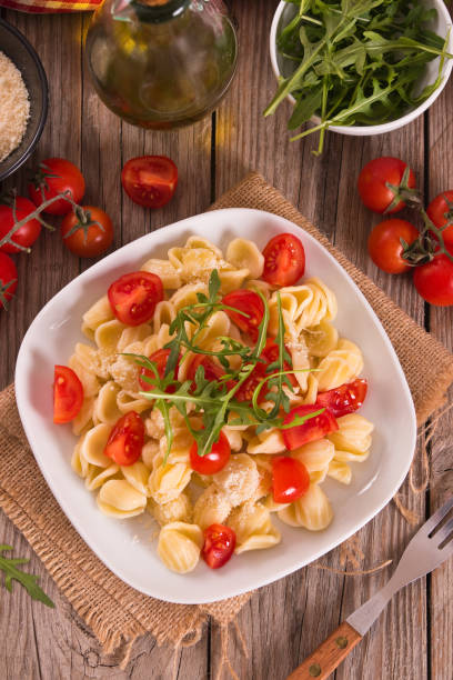 istock Orecchiette pasta with arugula and tomato. 1483232382