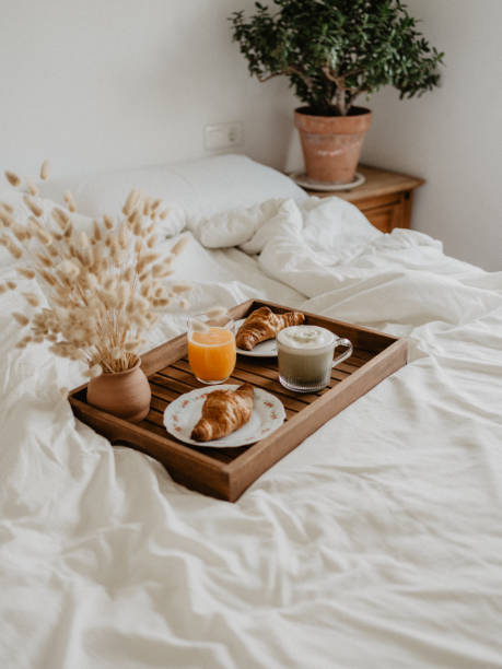 istock Breakfast in bed with orange juice, matcha latte and croissant 1483233200