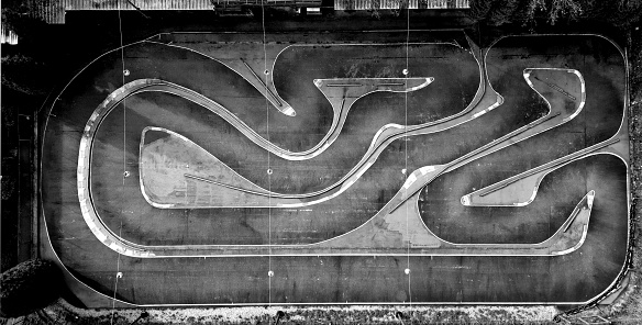 black and white aerial photo of a kart sports track. racing formulas have twisty turns and hatched asphalt edges for a better racing experience. for kids. monochrome, race track, carting