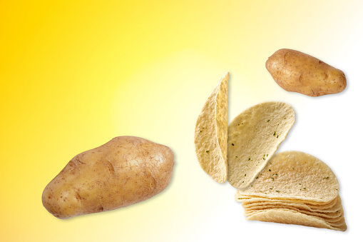 Potato chips on the light yellow background.