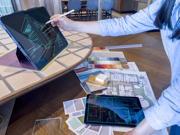 istock A female designer working with smart device and material sample at design studio. 1483234872