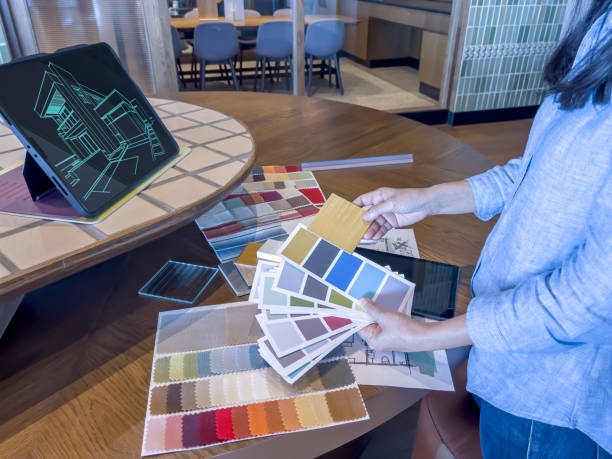 istock A female designer working with smart device and material sample at design studio. 1483234889