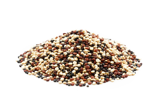 heap of quinoa seeds isolated on white background. a pile of quinoa seeds isolated on white background. quinoa seeds