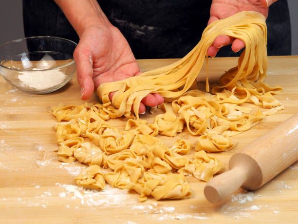 istock Female hands with dough for noodles and rolling pin 1483235499