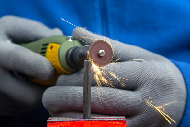 istock Worker processes metal with engraving drill close-up. The work of the dremel engraving electric tool. Industrial metal processing 1483237533
