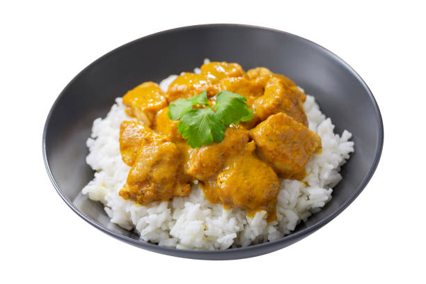 istock plate of chicken with curry sauce and rice on white background 1483238675