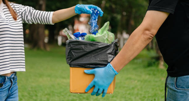istock people hand holding garbage bottle plastic and glass putting into recycle bag. plastic concept. 1483238913