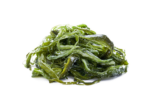 heap of fresh Korean salted seaweed salad stem side dish or Miyeok Julgi Bokkeum isolated on white background. Laminaria or Kelp Seaweed stem