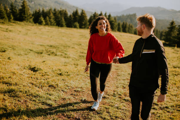 istock Smiling couple walking over green hills 1483239184