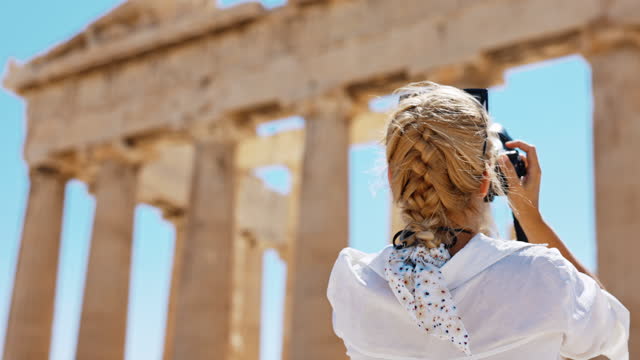 SLO MO Rear view of tourist photographing Parthenon temple with camera