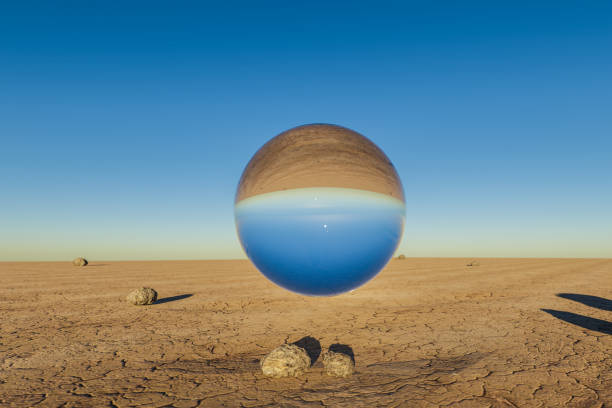single glas sphere ball hovering in the air in large empty desert environment; abstract surreal concept; 3D Illustration