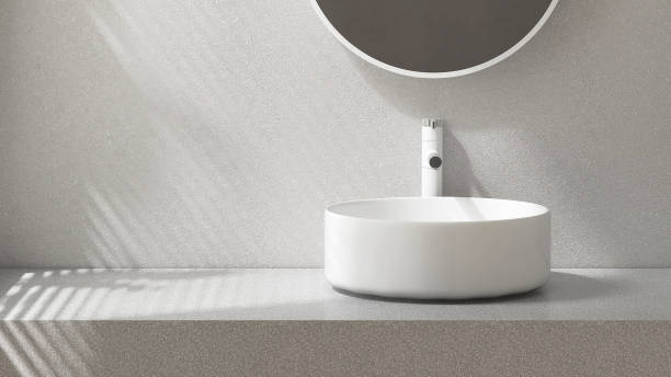 istock Modern gray stucco vanity counter, white round ceramic washbasin, mirror in sunlight from window blinds on wall luxury bathroom 1483240424