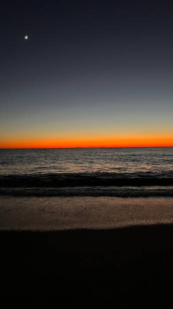 istock Sunset and moon on the beach 1483240757