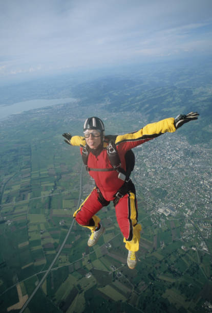 istock Skydiver in free fall above mountains and urban area 1483241813
