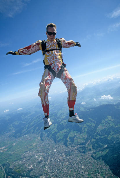 istock Skydiver in free fall above mountains and urban area 1483241912