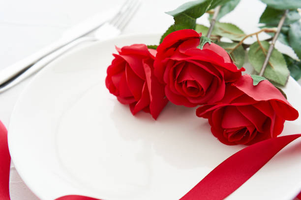istock table setting valentine dinner with red rose on white dish table food background. concept of valentine dinner food background. valentine dinner love 1483242044