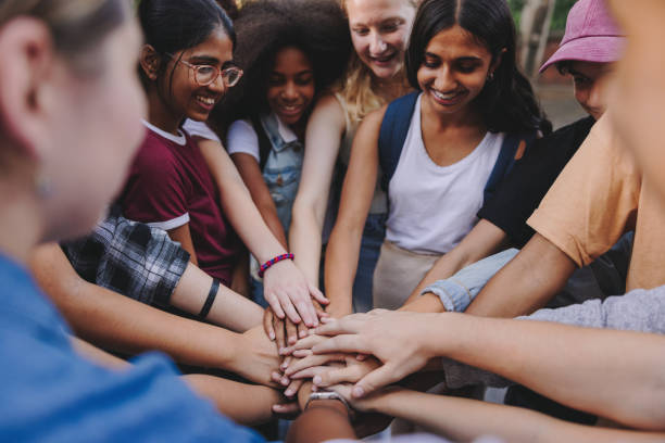 istock Generation Z youngsters putting their hands together in unity 1483242112