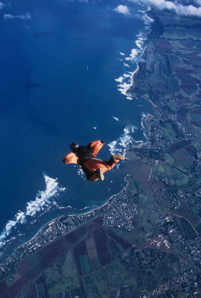istock Wing suit flier soars above sea 1483242189