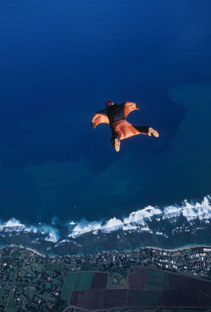 istock Wing suit flier soars above sea 1483242190