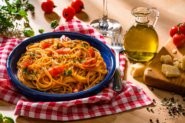 istock Spaghetti with tomato sauce served on wooden table 1483243224