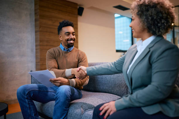 istock Happy black man shaking hands insurance agent in the office. 1483243703