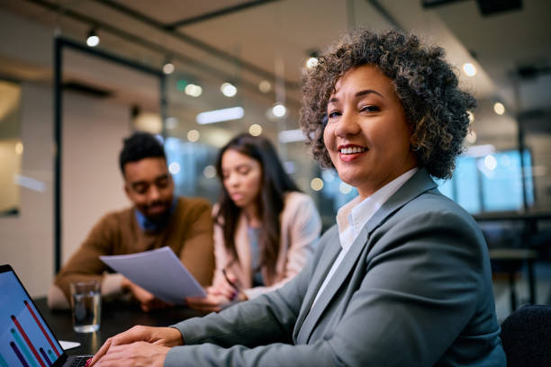 istock Happy financial advisor using laptop during a meeting with clients and looking at camera. 1483243994