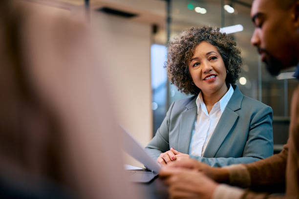 istock Smiling insurance agent having a meeting with her client in the office. 1483244034