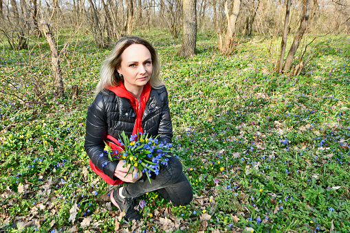 Mom and daughter pick the first spring flowers.