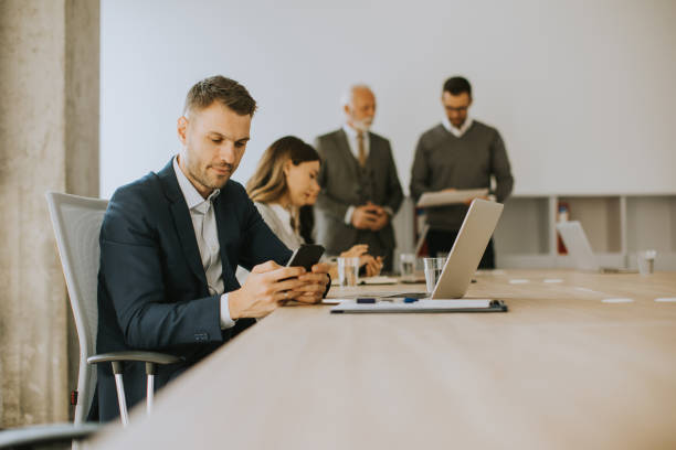 istock Young business man using mobile phone in the office 1483245206