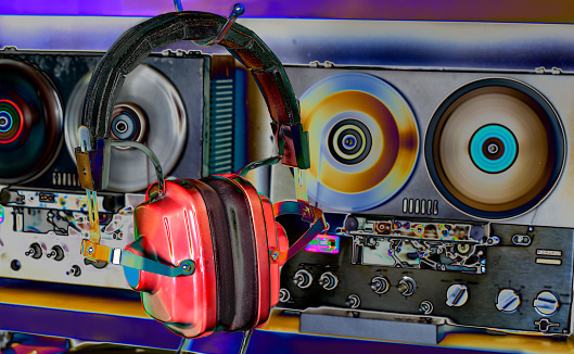 vintage headphones and reel to reel tape recorders, solarized colors, retro audio gear, nostalgia and hipster lifestyle
