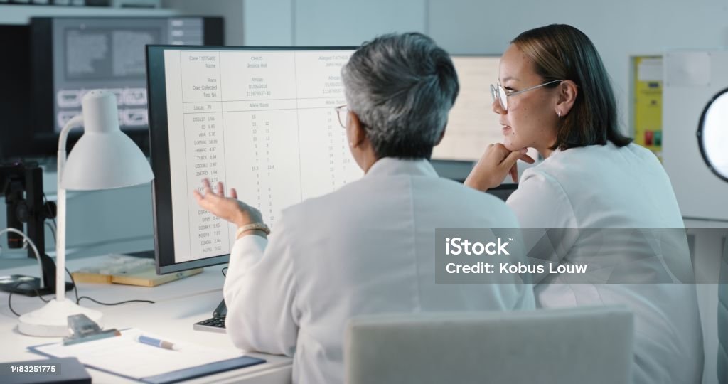 Science, hospital and women on computer for research, medical report and data analytics in laboratory. Healthcare, teamwork and female scientist in discussion for analysis, results and biotechnology Data Stock Photo