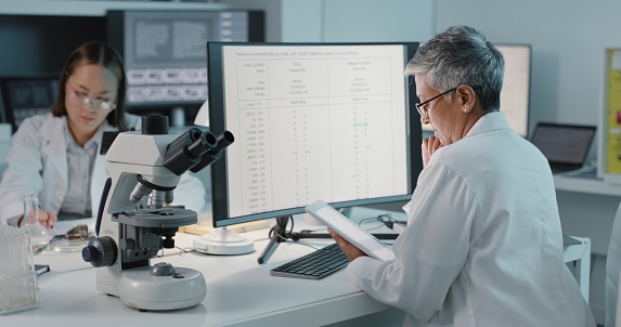 Research, tablet and science with a woman at work in a laboratory for innovation or breakthrough on a computer. Medical, data and technology with a female scientist working in a lab for discovery