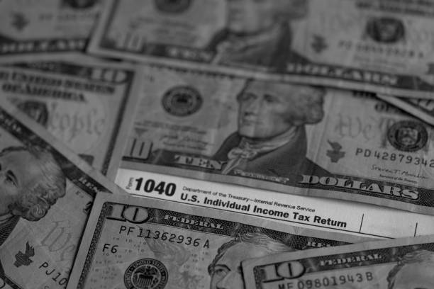 istock IRS form 1040 and dollars still life background 1483251986
