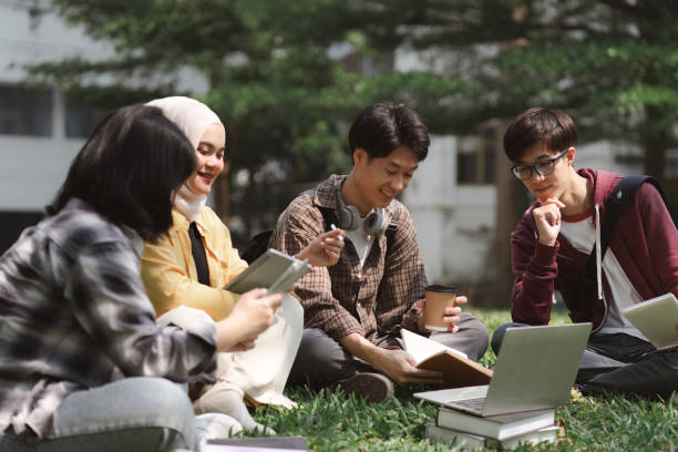 istock A multiethnic group of asian university students is seen studying together while sitting on the grass near the campus. 1483252719