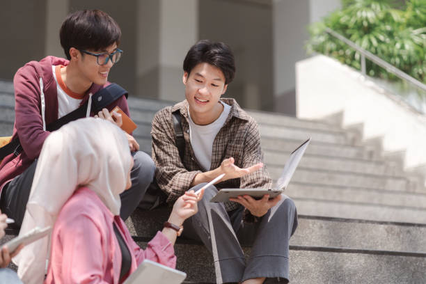 istock A multiethnic group of university students is studying together while sitting on steps near the campus and communicating with each other. 1483253275