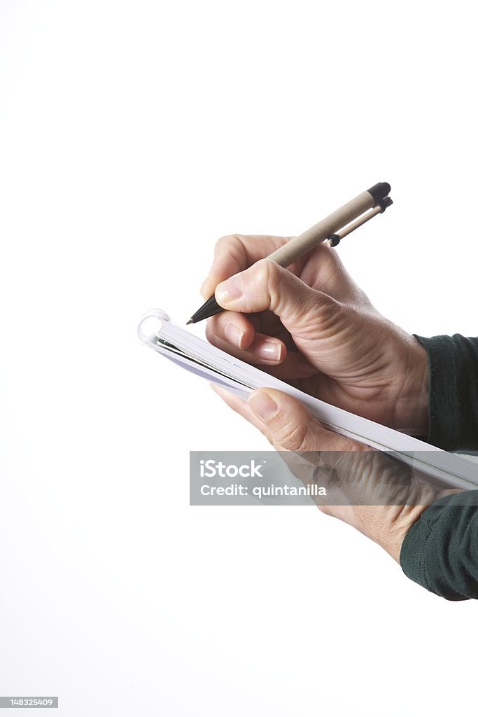 woman hands writing with pen on paper block isolated on white vertical detail view woman hands green sweater writing with pen on paper block notebook isolated on white Pencil Stock Photo