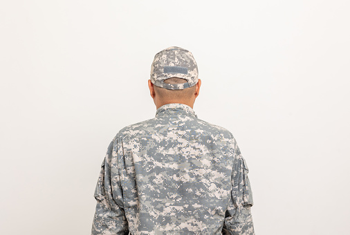 Rear view Asian man special forces soldier standing in studio. Commander Army soldier military defender of the nation in uniform standing on white background.